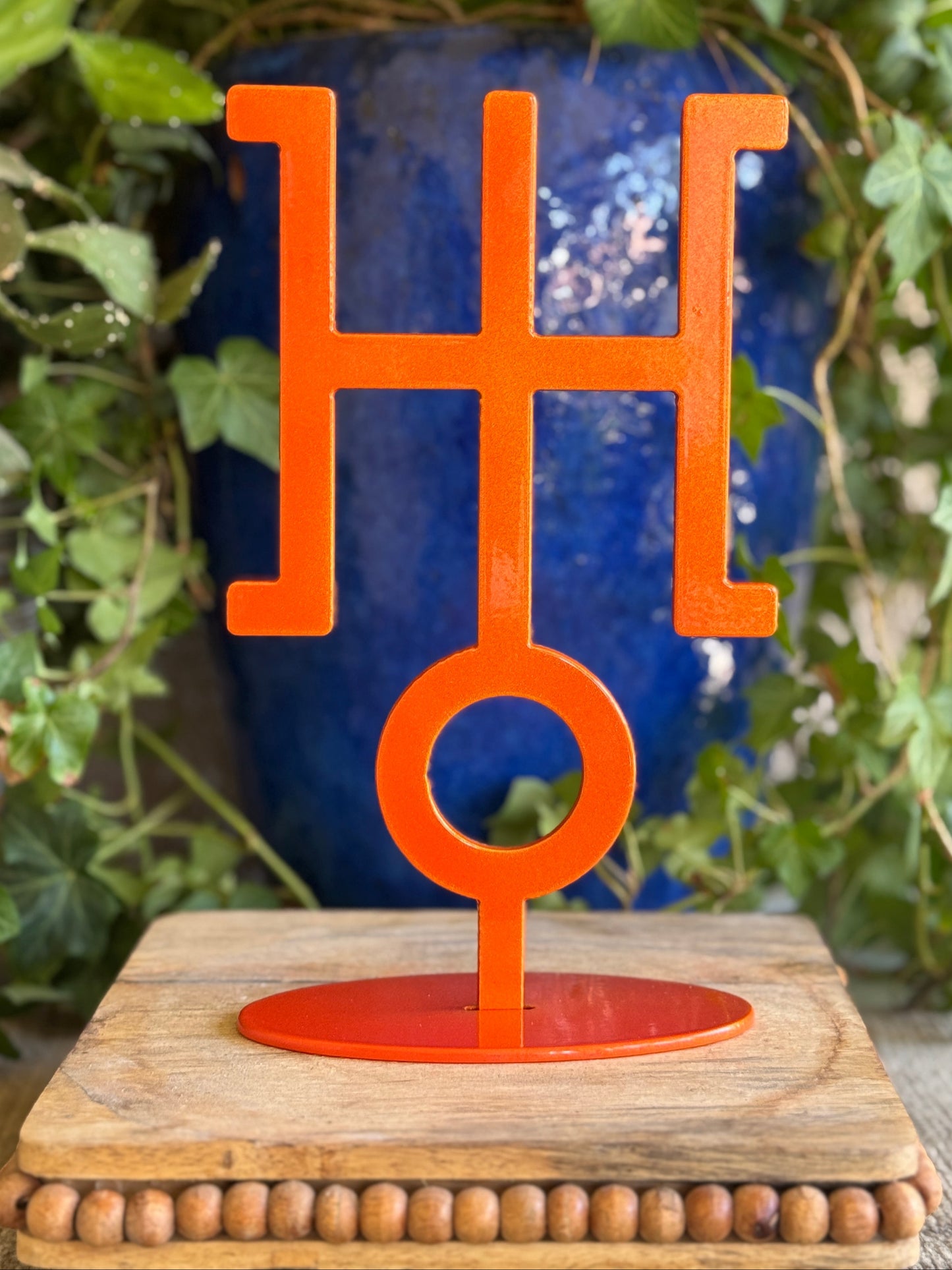 Uranus, orange metal statue