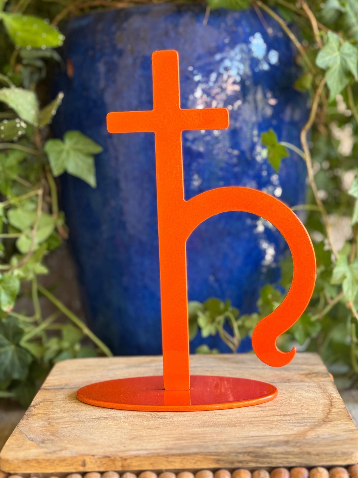 Saturn, orange metal statue