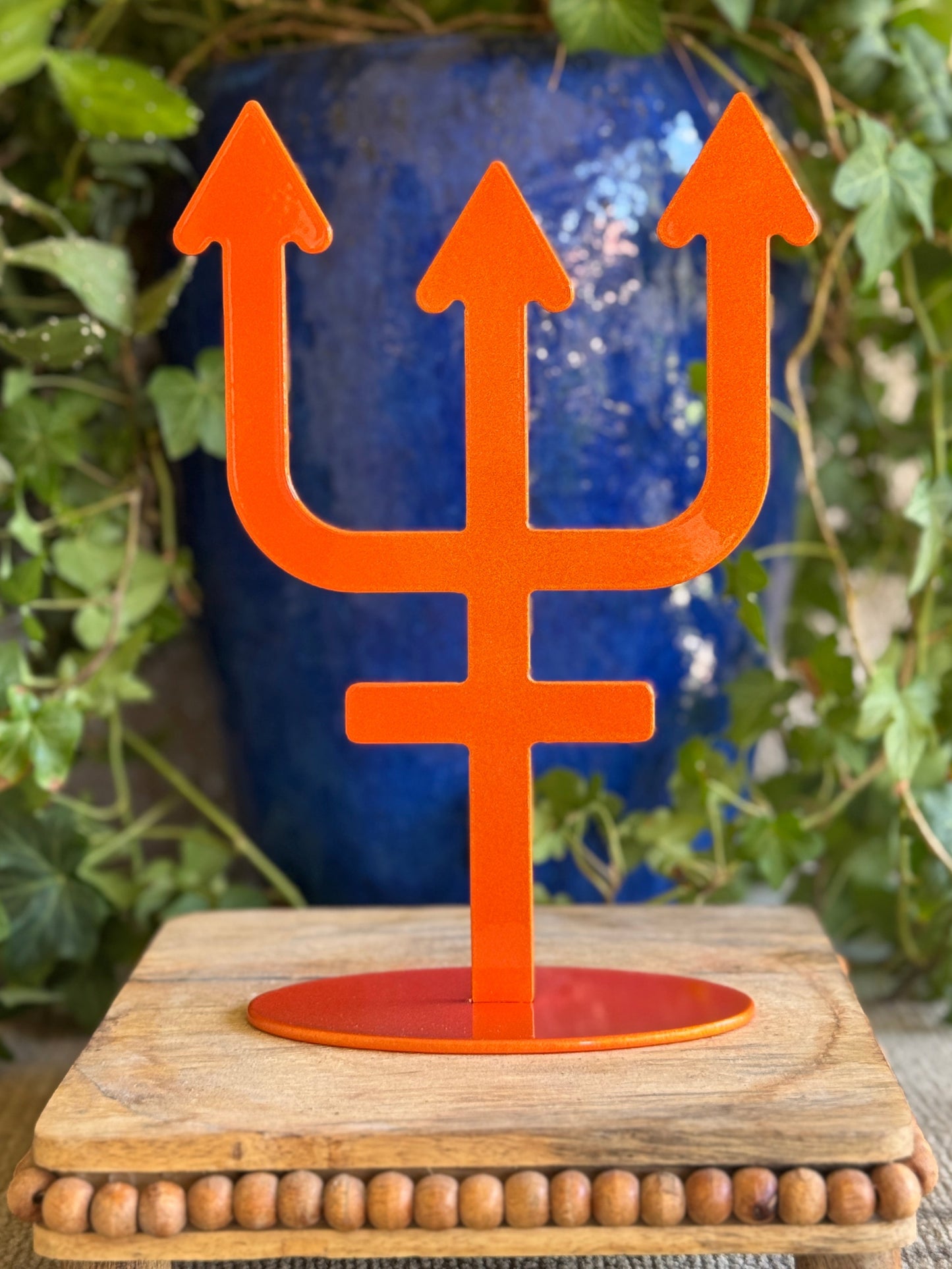 Neptune, orange metal statue