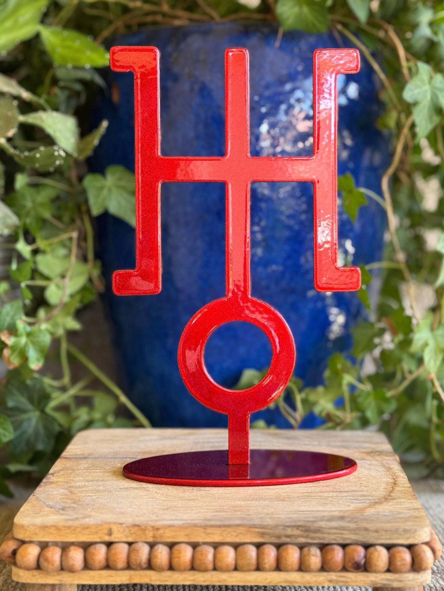 Uranus, red metal statue